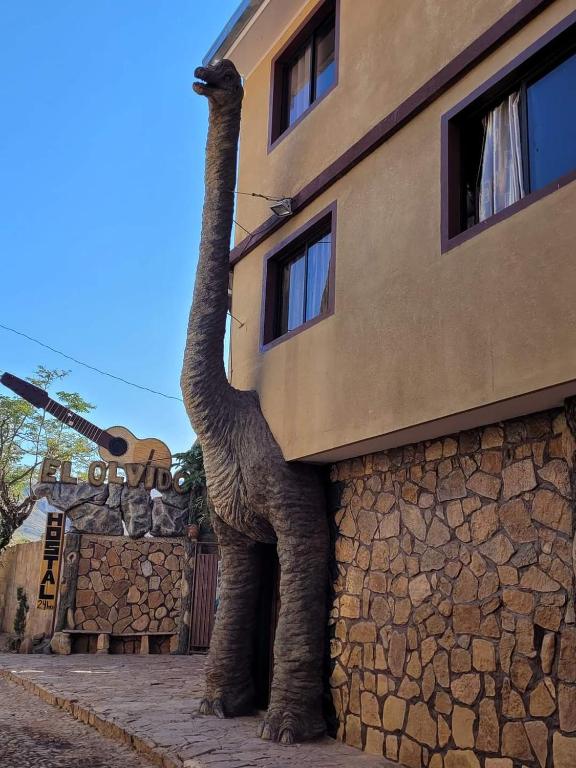 a statue of an elephant standing next to a building at Hostal y Restaurante El Olvido - Torotoro in Torotoro