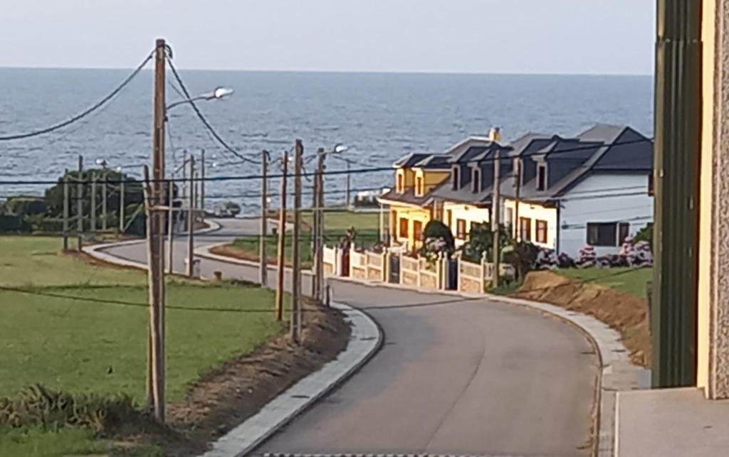 a house on a road next to the ocean at EnFOZ PLAYA DE LLAS in Foz