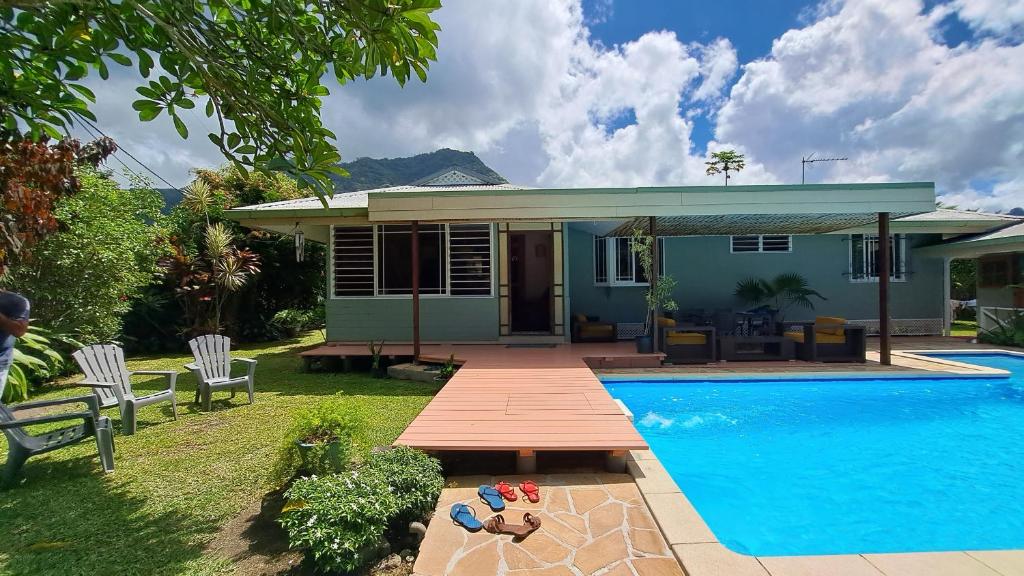 a small house with a swimming pool in front of it at TAHITI - Villa Fara in Papara