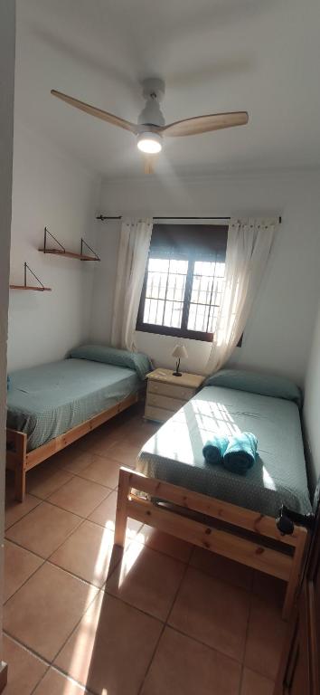 A bed or beds in a room at Chalet Santi Playa de la Barrosa