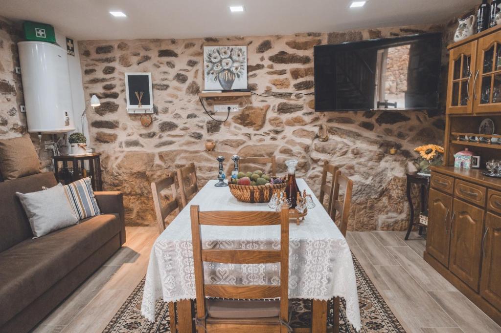 a living room with a table and a couch at Casa da Vovó Luisa in Quinta da Lama Redonda