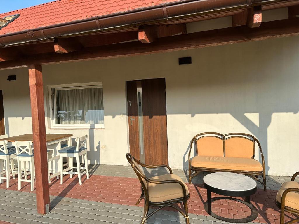 a patio with chairs and a table and a table and chairs at U Zgagi in Mikoszewo