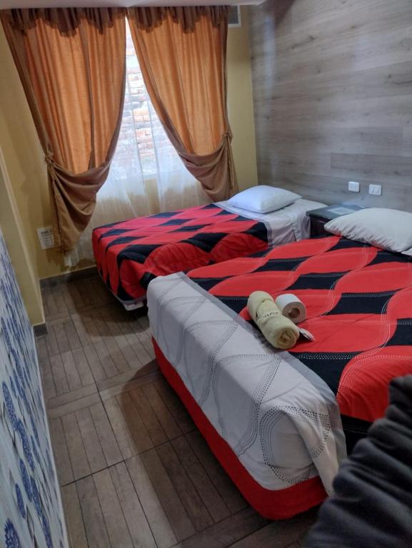 Postel nebo postele na pokoji v ubytování HOSPEDAJE YACUCALLE