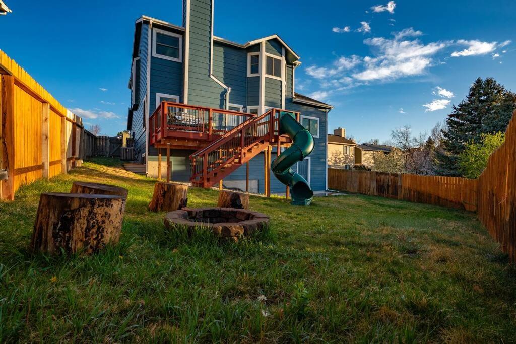 a yard with a playground in front of a house at Hillcrest Chalet - Spa - Mountain Views - Fire Pit - Slide -9min to USAFA in Colorado Springs