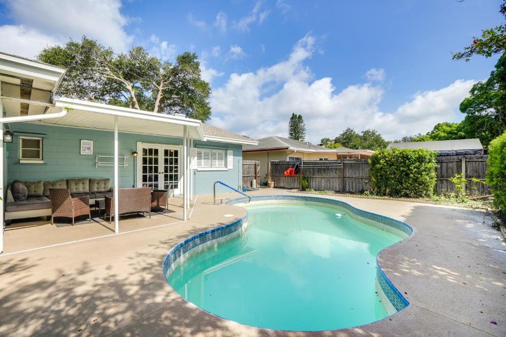 a swimming pool in front of a house at Near Busch Gardens Sunny Florida Retreat with Pool! in Palm Harbor