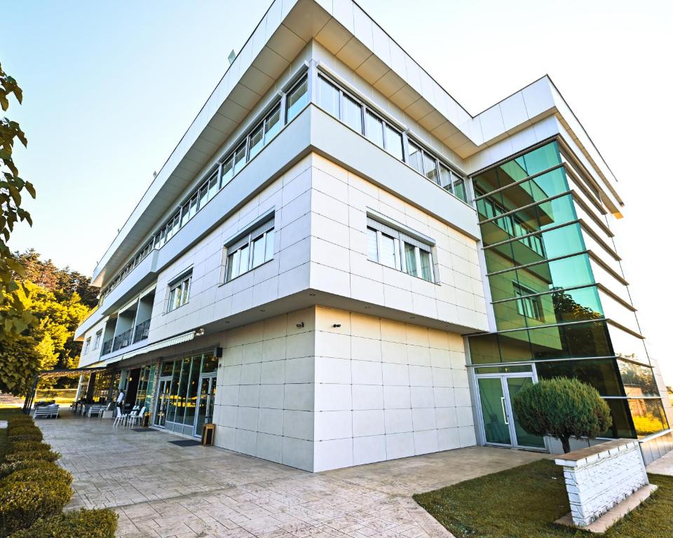 a large white building with a lot of windows at Hotel La Villa in Gjakove