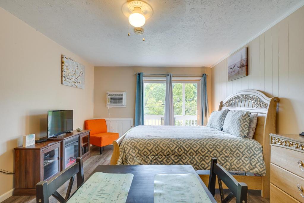 a bedroom with a bed and a television and a table at Inviting New River Gorge Studio! in Fayetteville