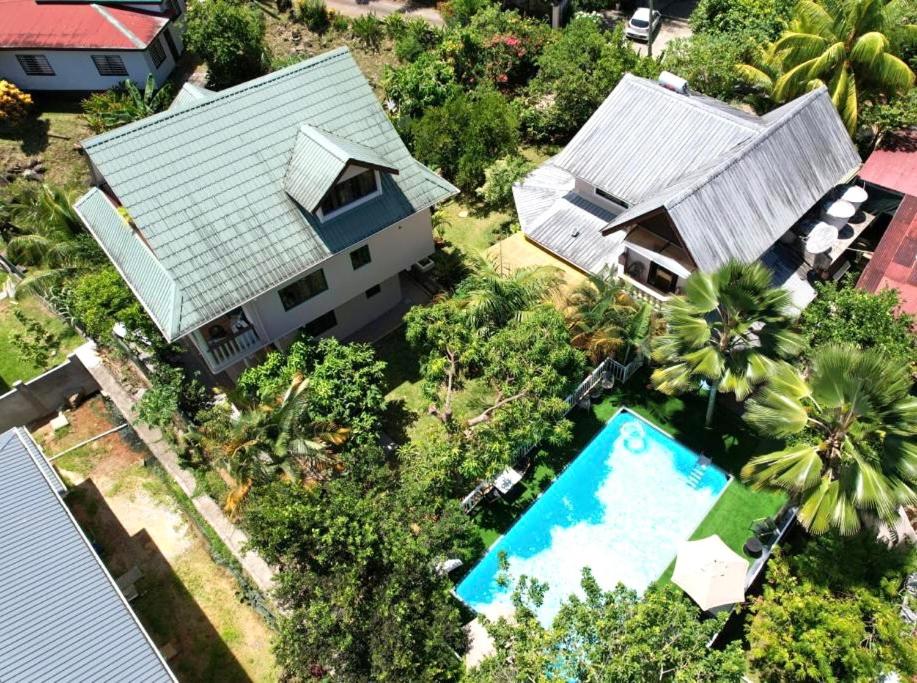 an overhead view of a house and a swimming pool at Belle Montagne Holiday Apartments in Grand'Anse