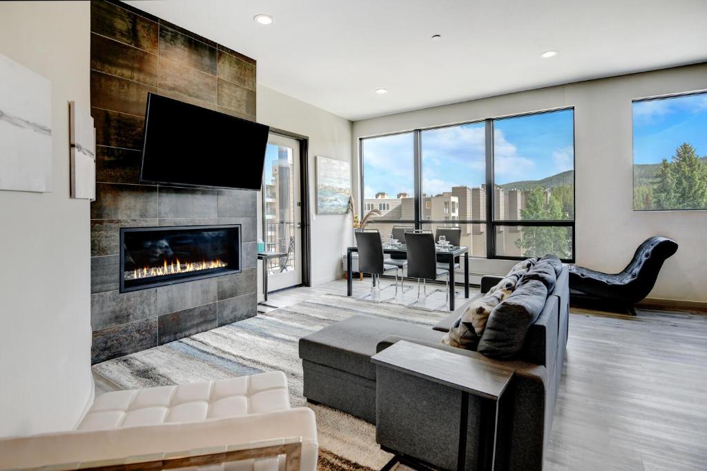 a living room with a couch and a fireplace at New Ski In Out Luxury Loft #201 With Hot Tub, Gym & Great Views - 500 Dollars Of FREE Activities & Equipment Rentals Daily in Winter Park