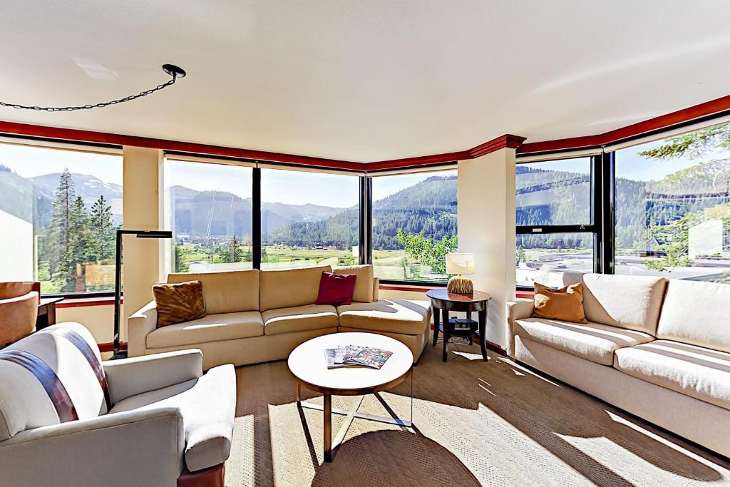 a living room with couches and large windows at Resort at Everline Resort & Spa #560 in Olympic Valley