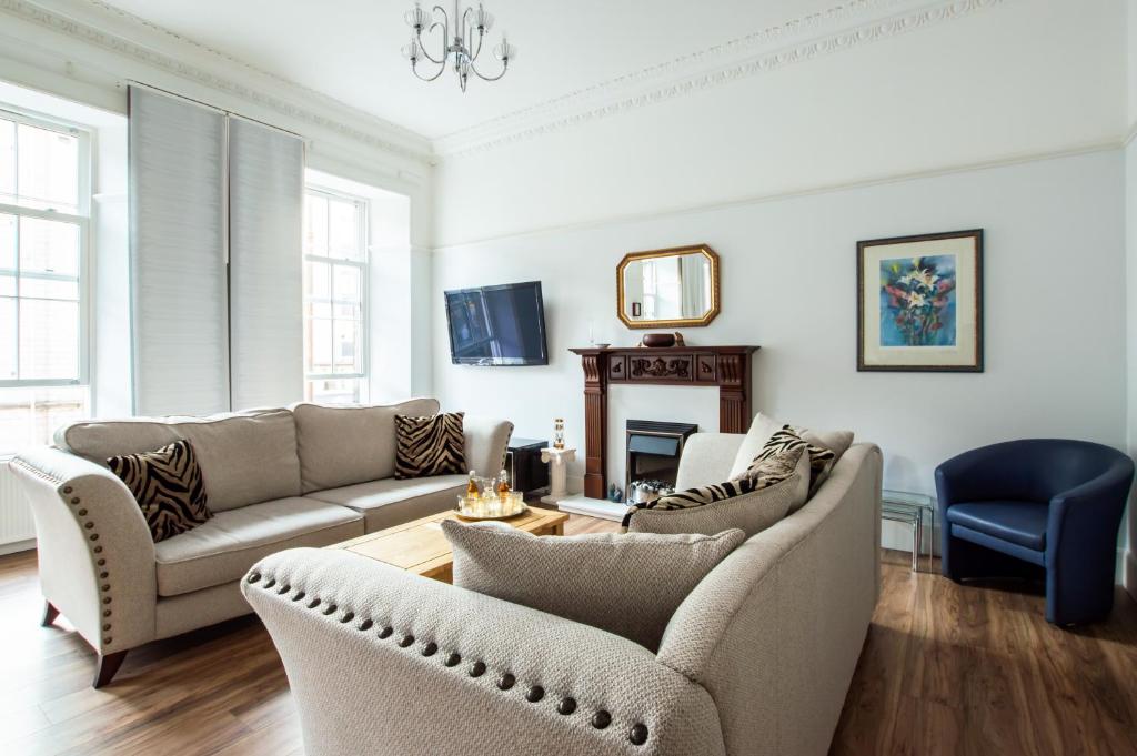 a living room with two couches and a table at The Heart of Newington in Edinburgh