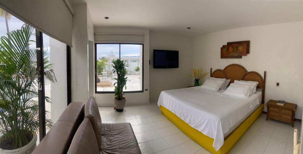 a bedroom with a bed and a large window at El Peñón, Girardot-Colombia in Girardot