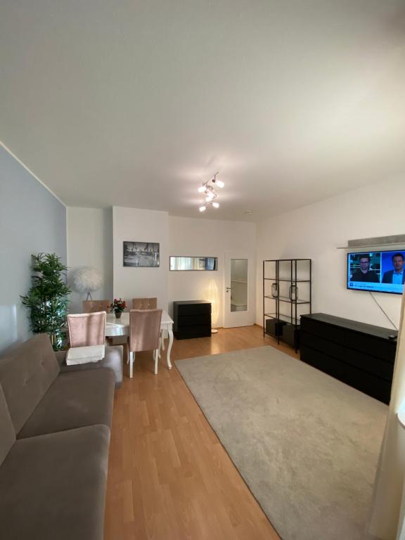 a living room with a couch and a table at Zentraler Komforttraum in Berlin