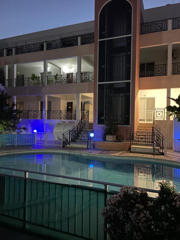 ein Schwimmbad vor einem Gebäude in der Nacht in der Unterkunft Cozy Paphos Apartment in Paphos City