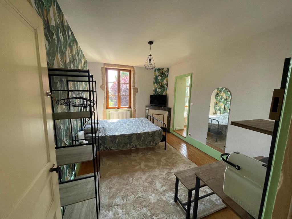 une chambre avec un lit et un miroir dans l'établissement Le Clos des Cadots - Chambre, à Chaintré