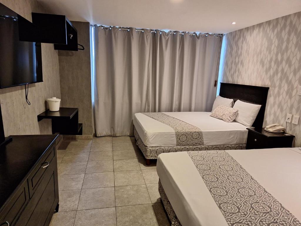 Postel nebo postele na pokoji v ubytování Hotel Costa Verde