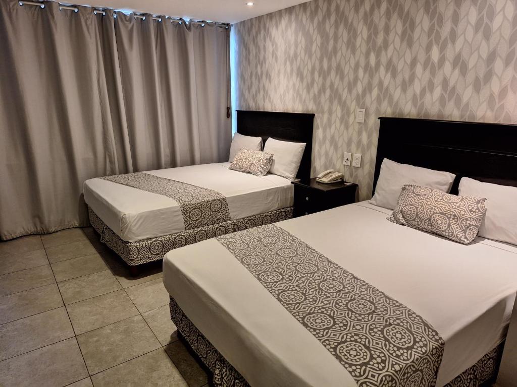 Postel nebo postele na pokoji v ubytování Hotel Costa Verde
