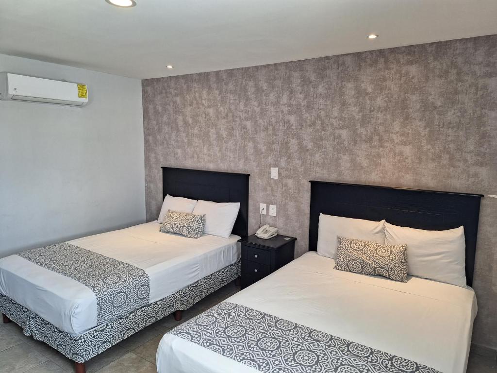 Postel nebo postele na pokoji v ubytování Hotel Costa Verde