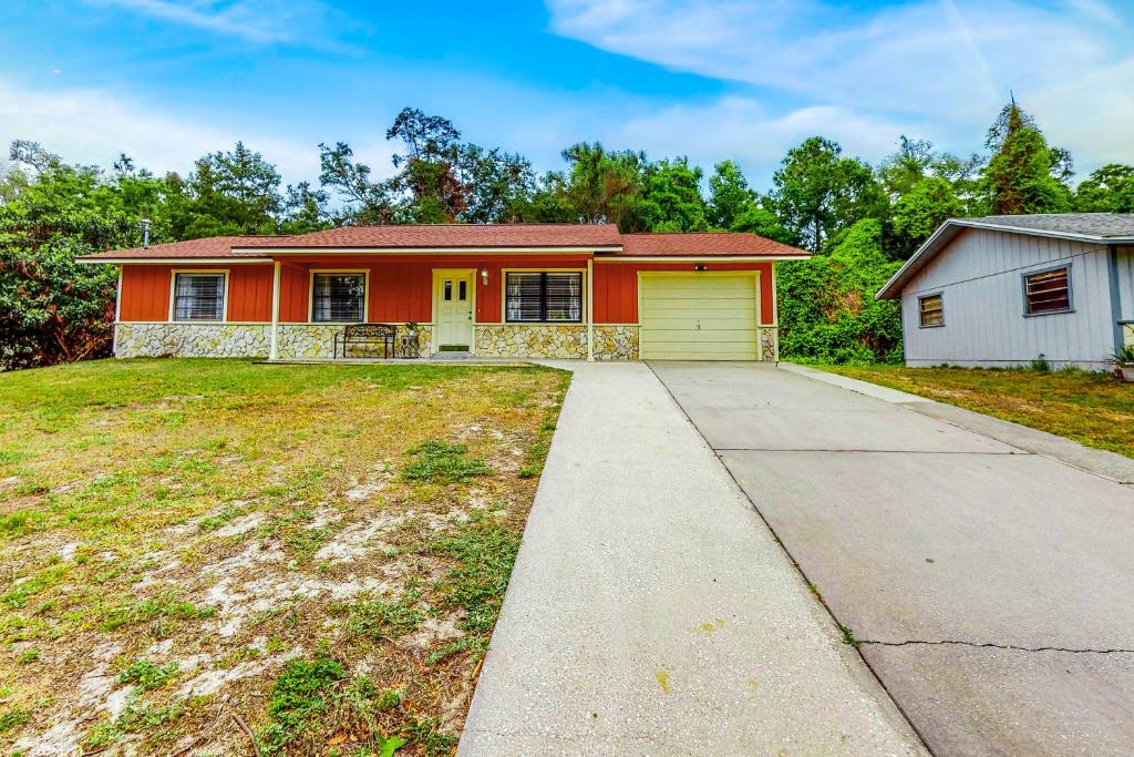 a house with an empty driveway in front of it at Little Hawk Villa in Crystal River