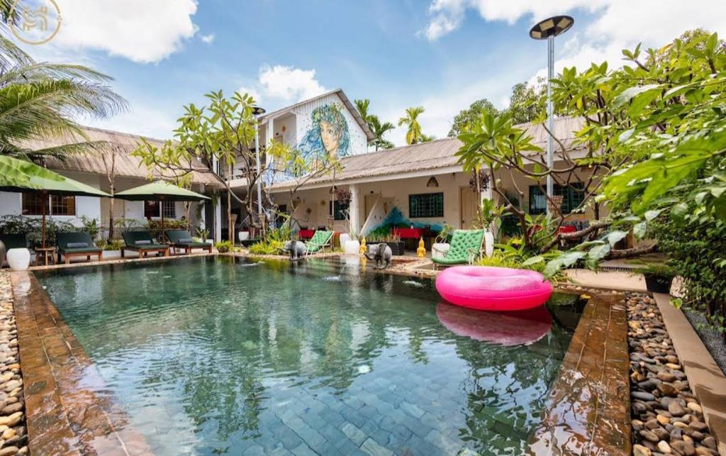 a house with a swimming pool in front of a house at Green BOUTiQUE in Siem Reap