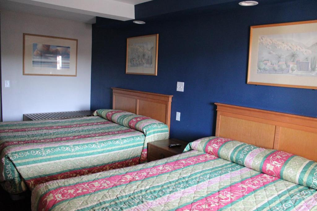 Postel nebo postele na pokoji v ubytování Flagstaff Motel
