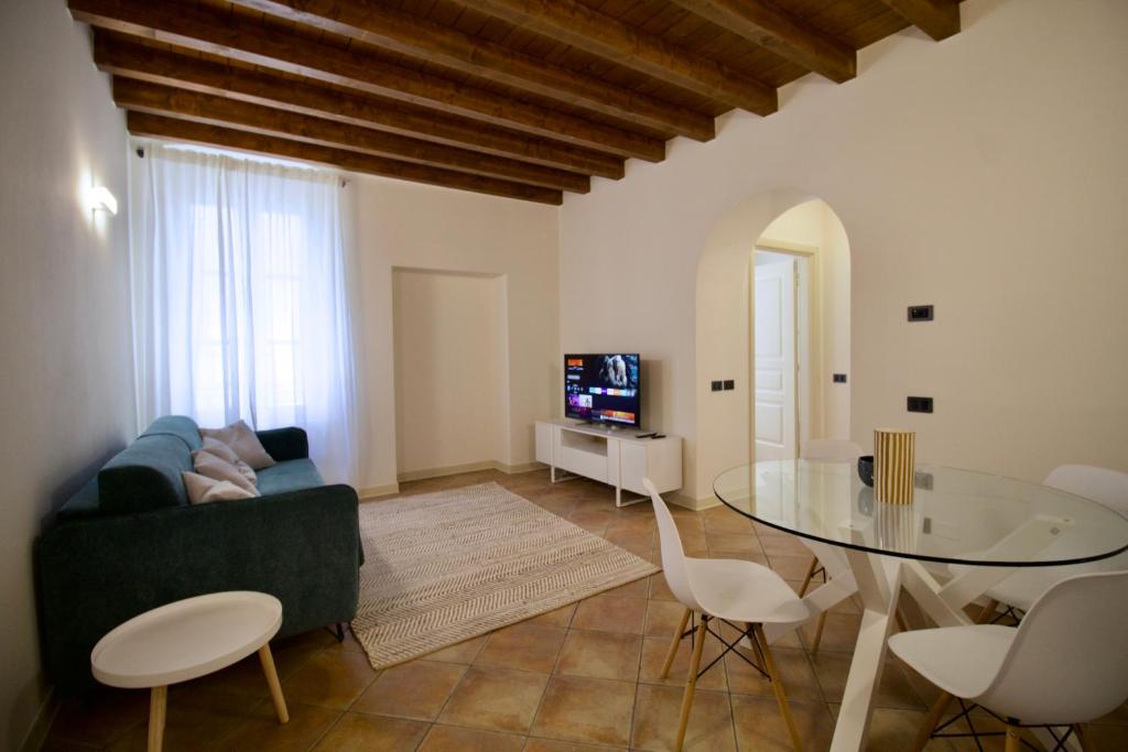 een woonkamer met een bank en een glazen tafel bij Dolce Vita Apartment - Salò in Salò