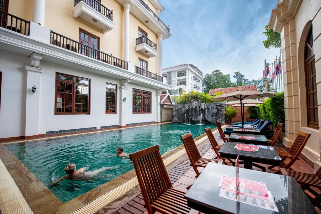a couple swimming in a pool in a house at Royal Crown Hotel & Spa in Siem Reap