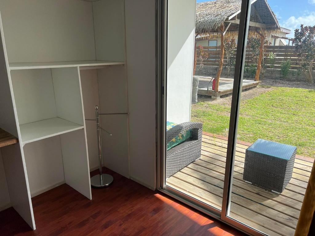 a room with a sliding glass door to a balcony at Te Mao in Avatoru