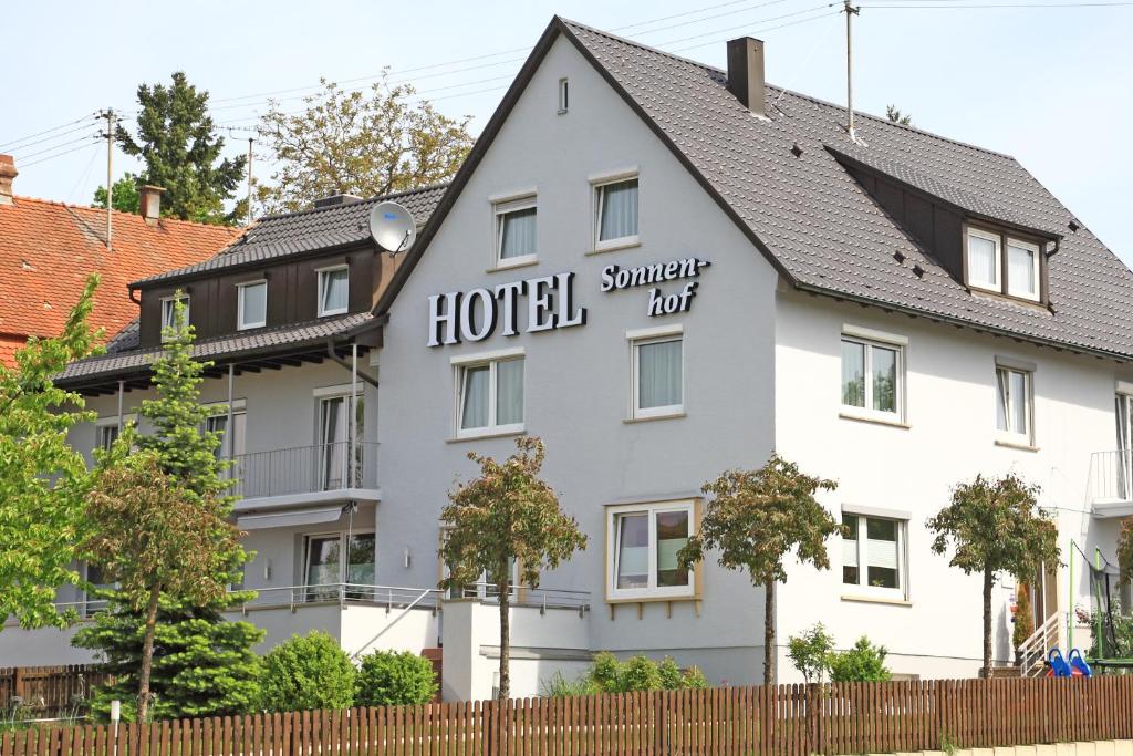 a hotel with a sign on the side of a building at Hotel Sonnenhof in Sindelfingen