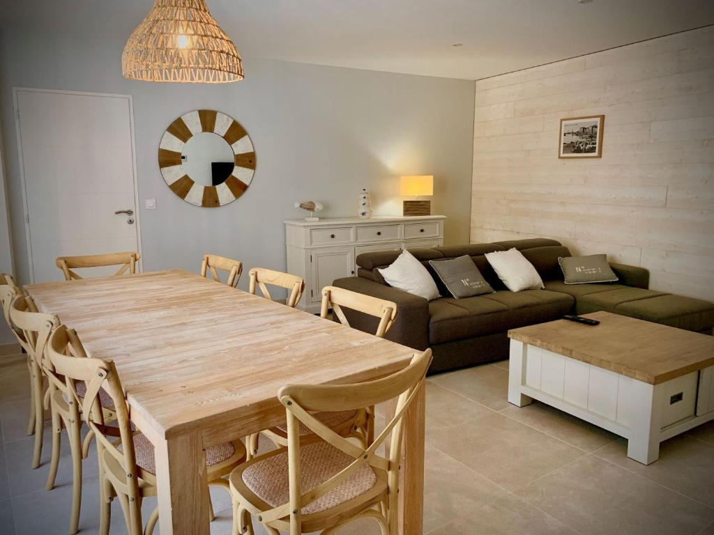 ein Wohnzimmer mit einem Tisch und einem Sofa in der Unterkunft Maison Mèze, 6 pièces, 8 personnes - FR-1-604-43 in Mèze