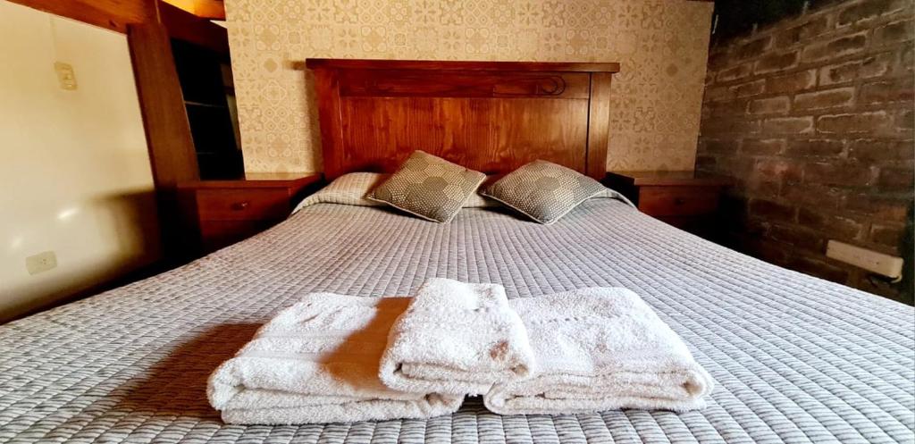 a bedroom with a bed with towels on it at Departamento completo in Ciudad Lujan de Cuyo