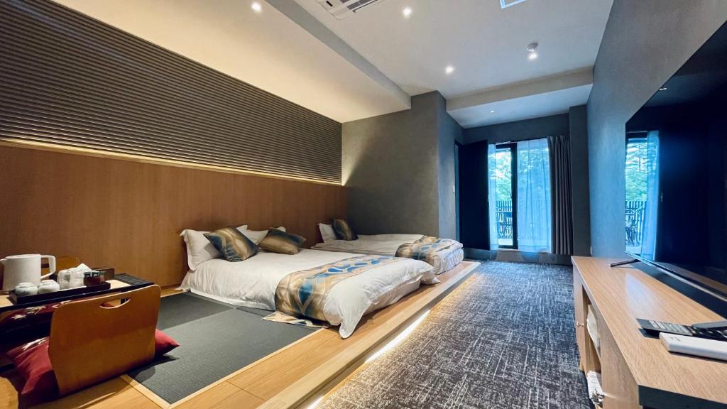 Postel nebo postele na pokoji v ubytování Kurobe Sunvalley Hotel