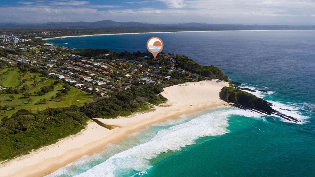 a hot air balloon flying over a beach at A Vista in Forster