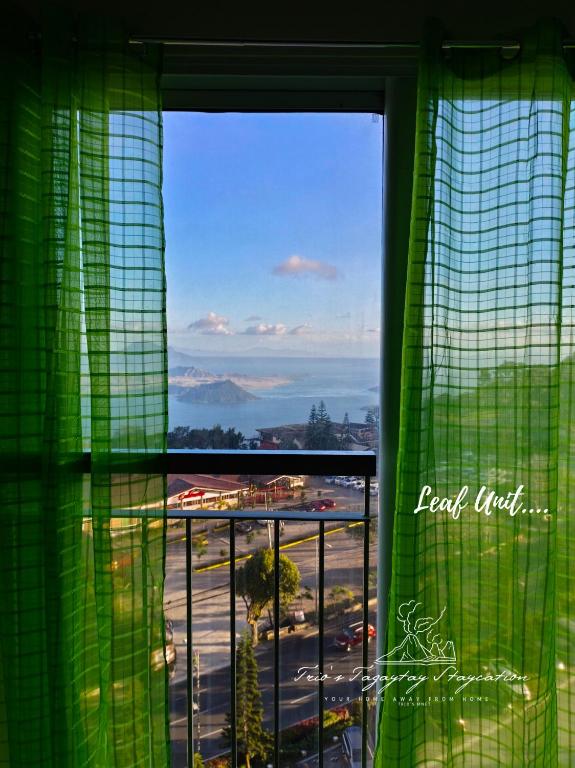 a window with a view of a parking lot at Leaf Taal View No Balcony in Tagaytay