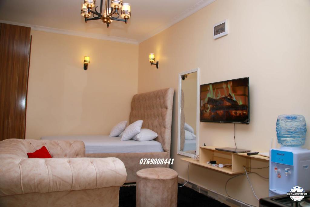 a living room with a bed and a couch at Denverwing Homes in Eldoret