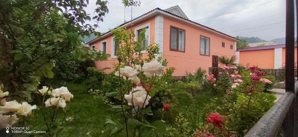 a pink house with flowers in front of it at Gabala Mountains Villa in Gabala