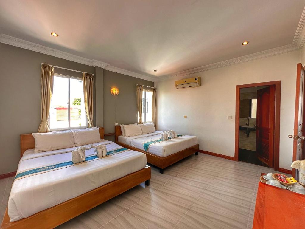 Postel nebo postele na pokoji v ubytování Villa Um Theara, Siem Reap