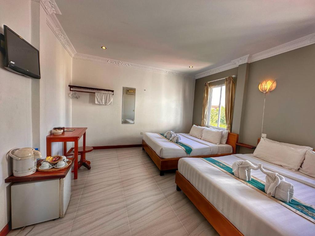 Postel nebo postele na pokoji v ubytování Villa Um Theara, Siem Reap
