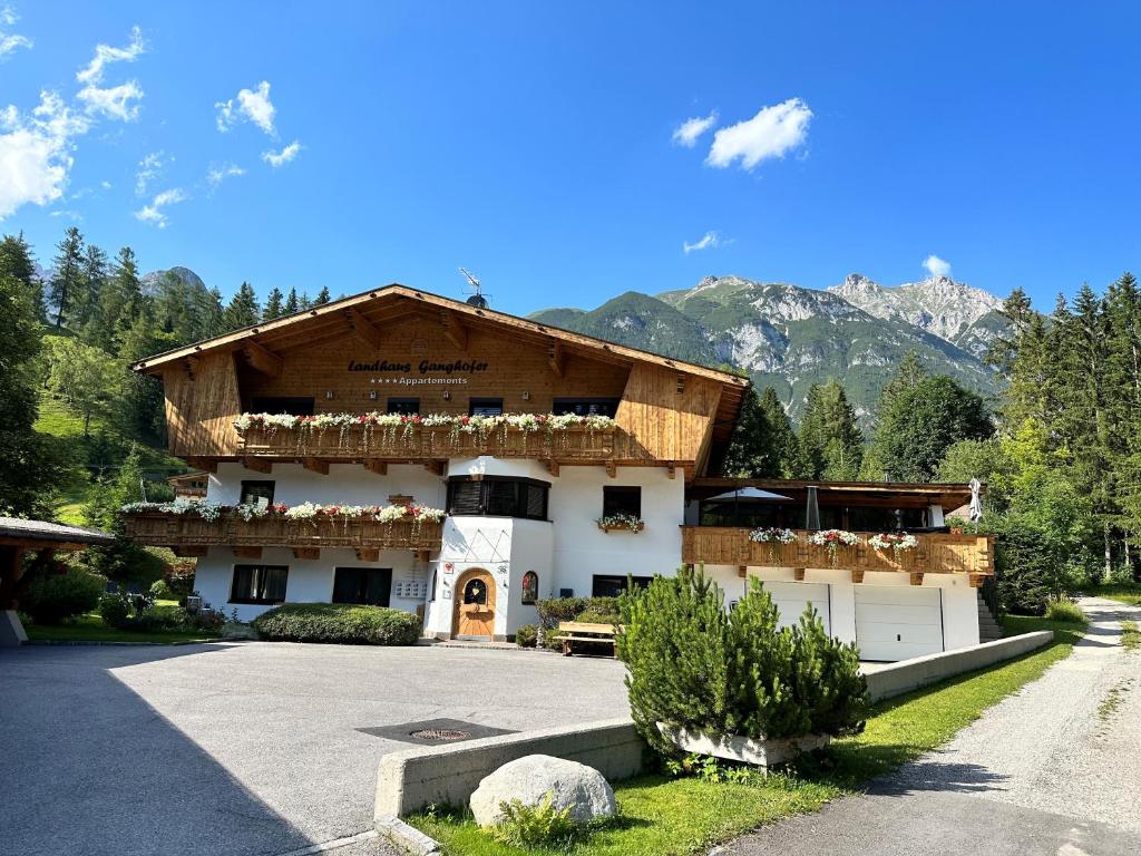 a large building with mountains in the background at W1 Haus Ganghofer in Leutasch