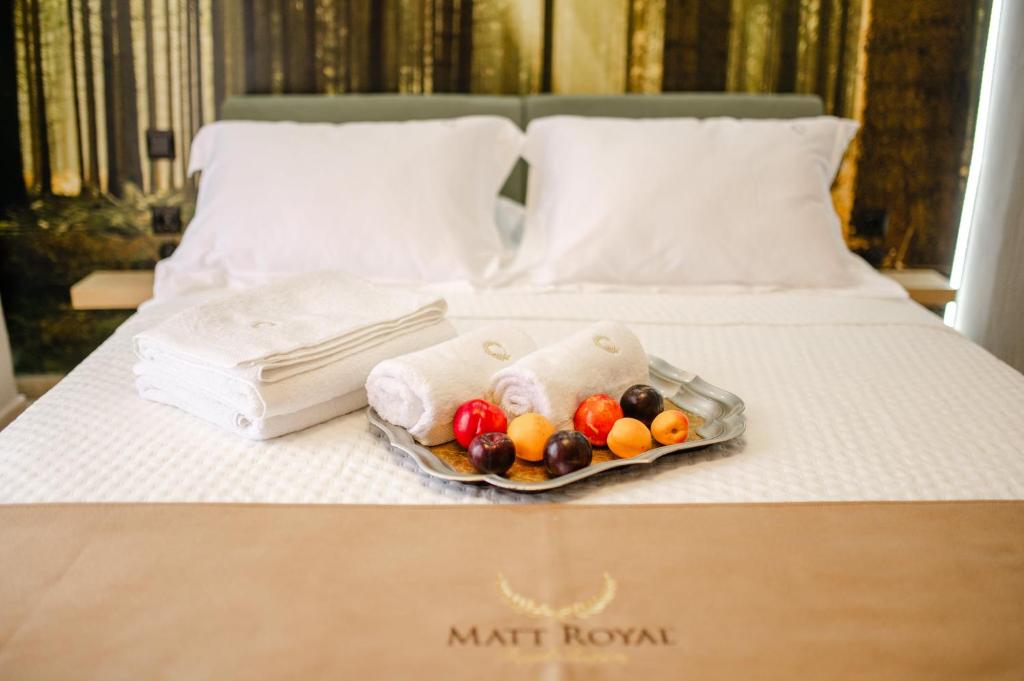 a tray of fruit and towels on a bed at PELAGIO APARTMENT 1 in Alexandroupoli