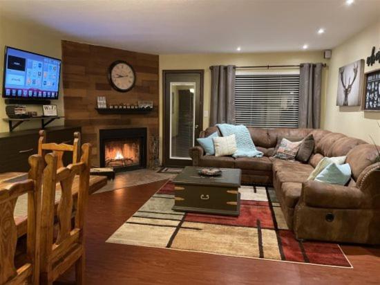 a living room with a couch and a fireplace at Giant Steps 63 Ski In-out in Brian Head