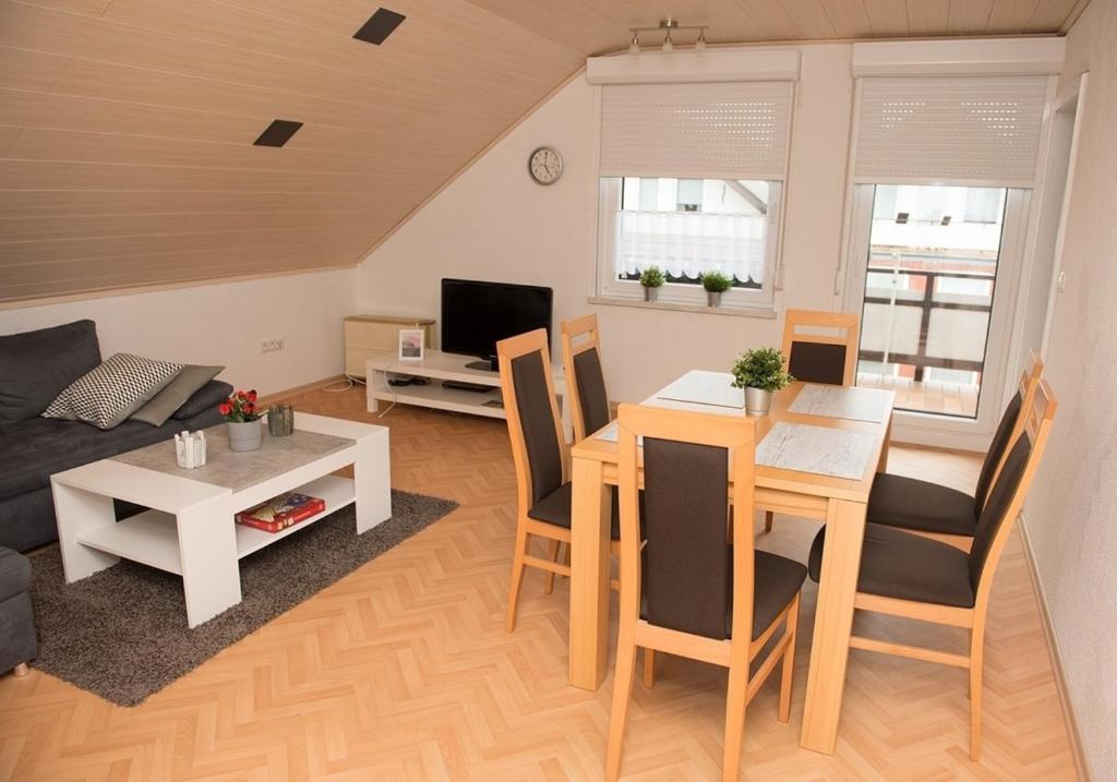 a living room with a table and a dining room at Fewo 91 WHG A 22 in Burhave in Burhave