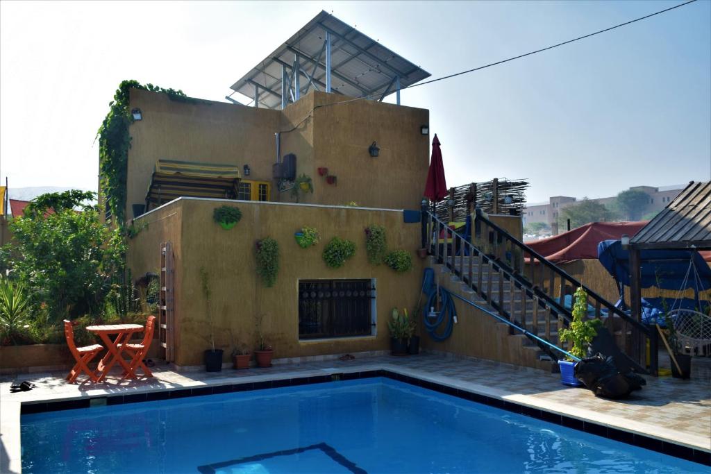 a swimming pool in front of a house with a staircase at Venus Chalet Farm 