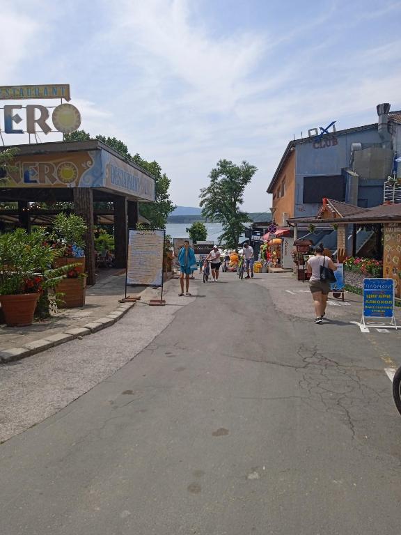 a street with shops and people walking down a street at APARTMENT 8 Primorsko АПАРТАМЕНТ 8 Приморско in Primorsko