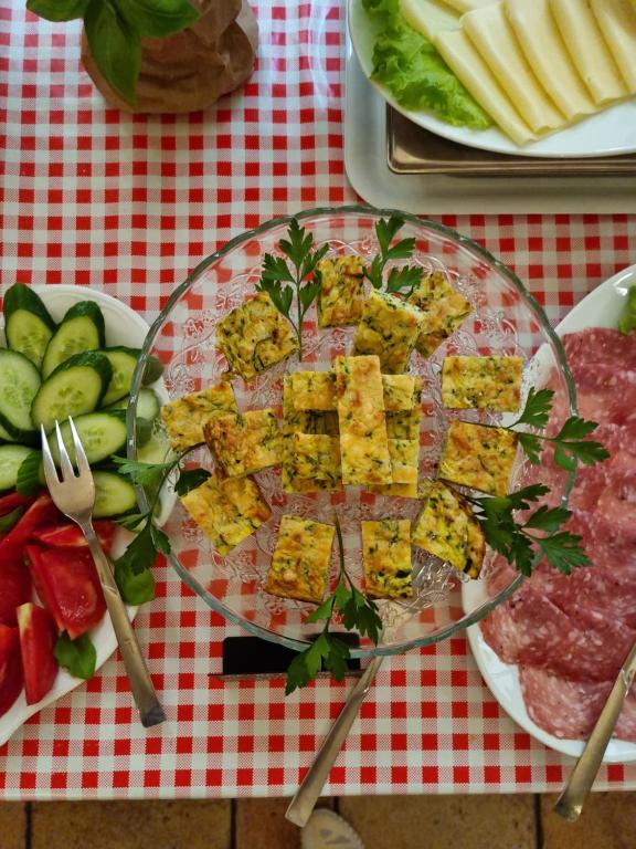 a glass plate of food on a table with fruit at Hotel Vittoria in Riva del Garda