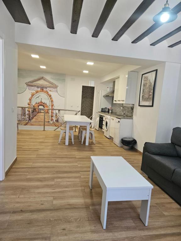a living room with a table and a couch at Apartamentos Plaza Santo Domingo in Cádiz