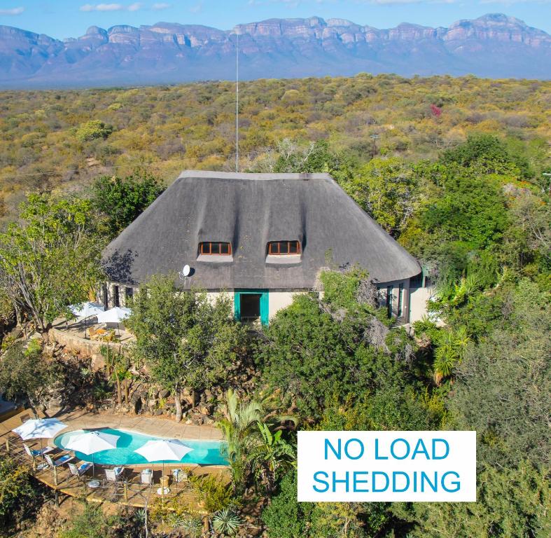a house with a no load shedding sign in front of it at The Wild Blue Lodge SAFARI & SPA in Hoedspruit