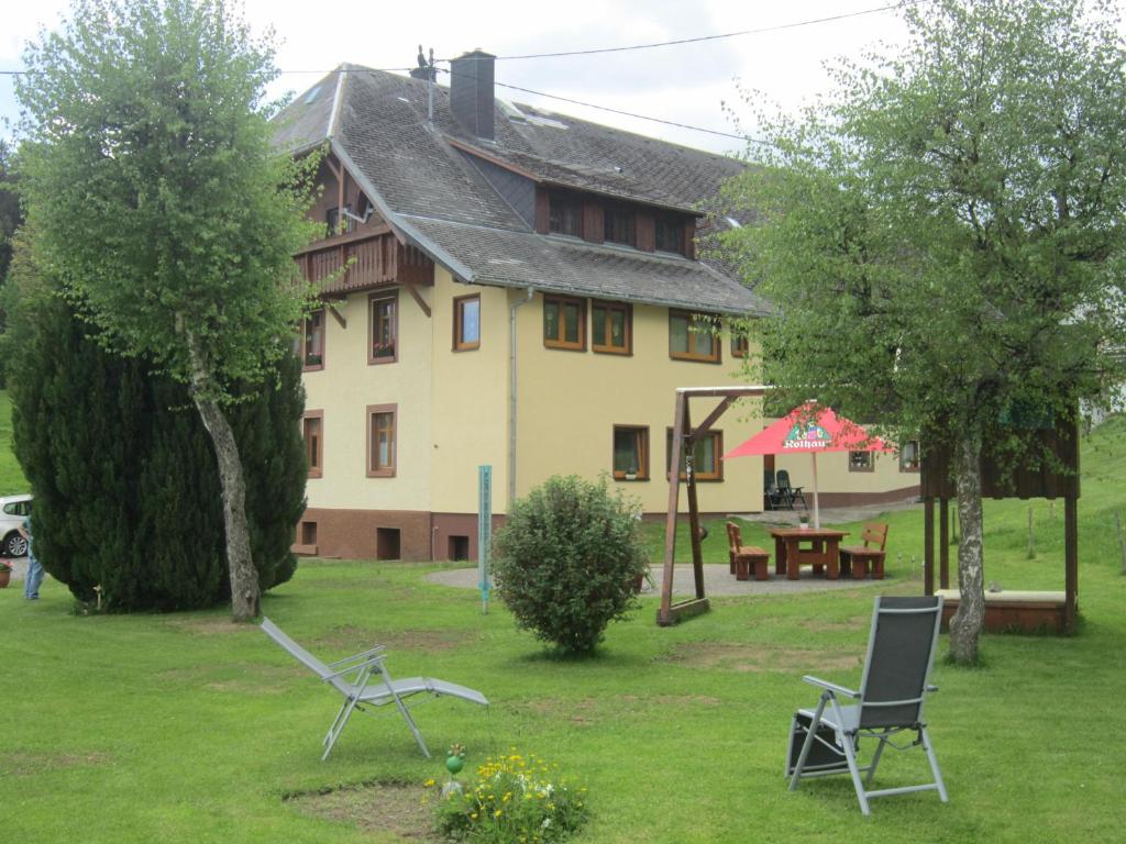 a house with chairs and a table in the yard at Haus Brunner in Grafenhausen