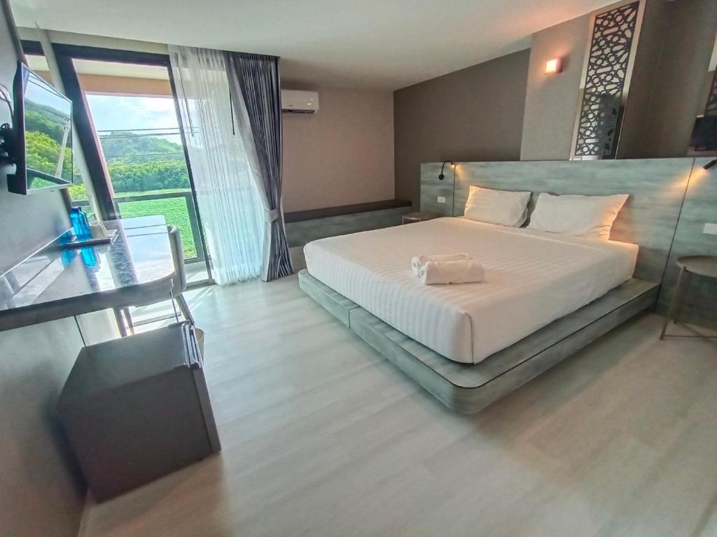 Postel nebo postele na pokoji v ubytování วัน บัดเจท เชียงราย เชียงแสน One Budget Hotel Chiangrai Chiangsaen