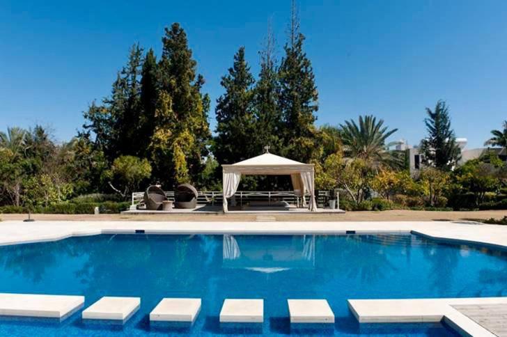 a swimming pool with a gazebo in a yard at The Dudai Titanic Mansion in Savyon